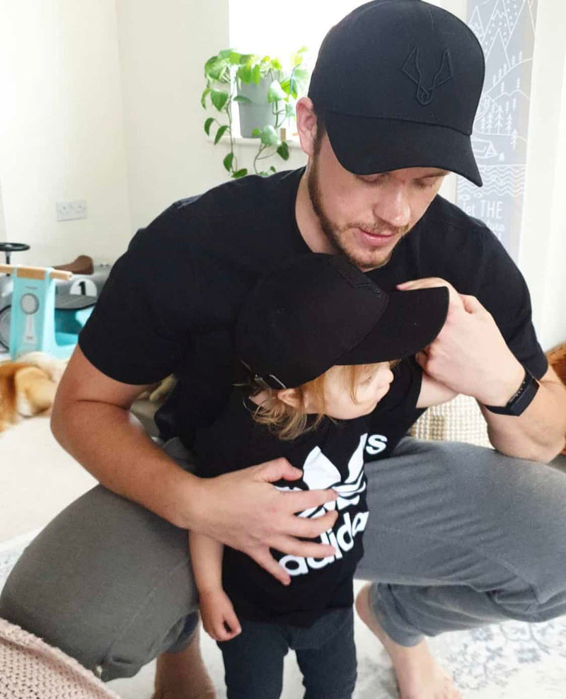 Dad and son wearing matching caps