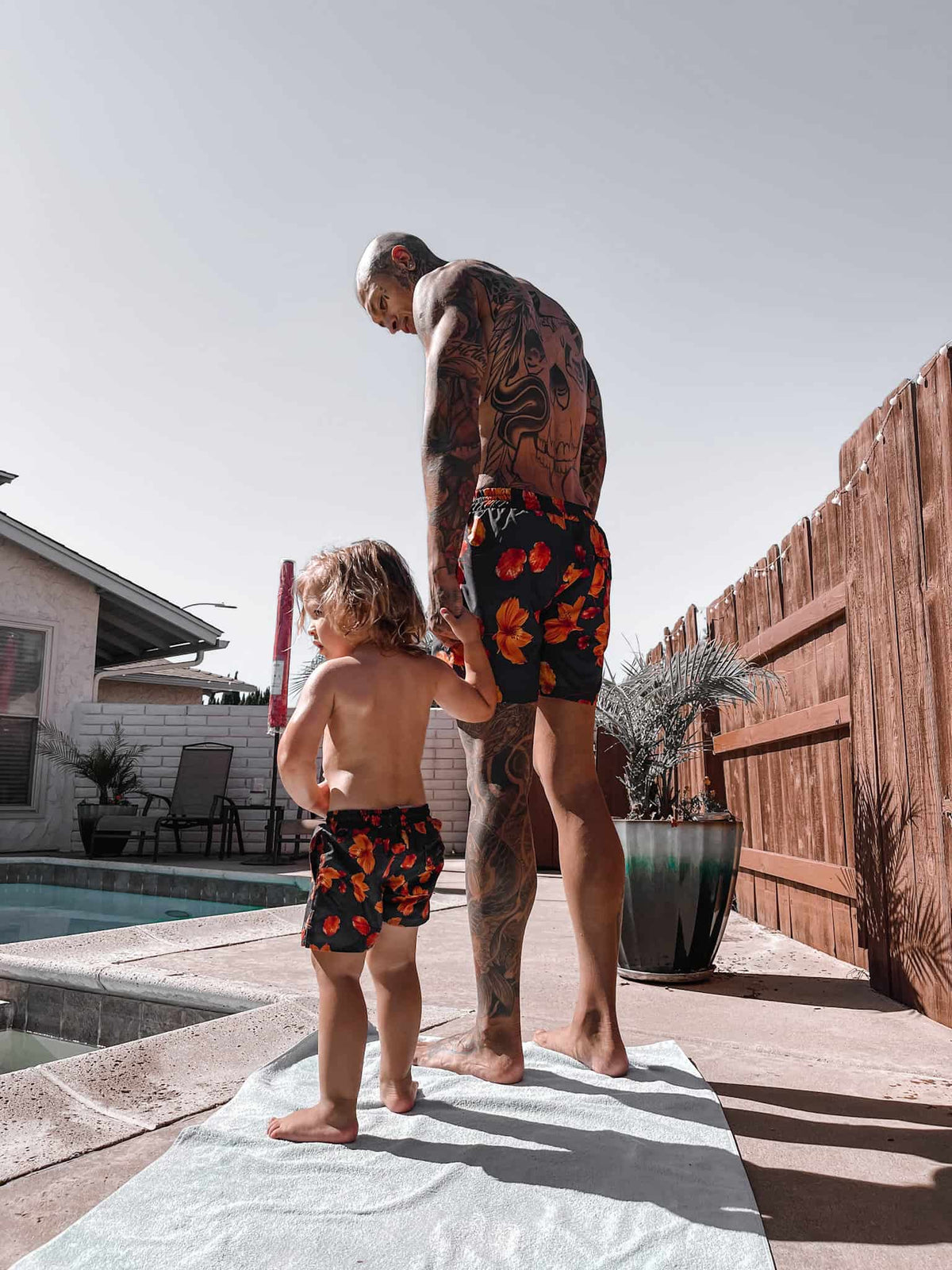 MANCUBERS WEARING OUR ORANGE BLOOM SWI SHORTS