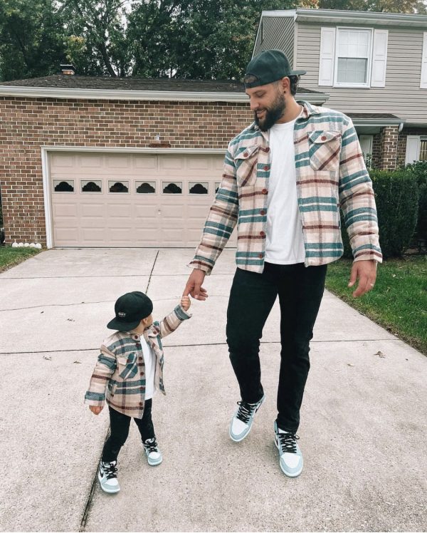 Father and son wearing matching MANCUB checked flannel jackets