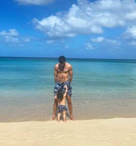 Father and son in Barbados wearing matching swim shorts