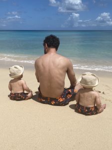 Dad with twins in matching swimshorts